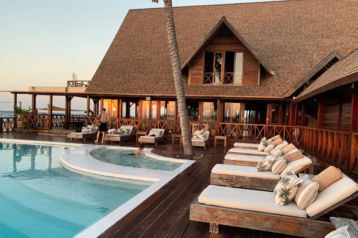 Luxury resort pool deck and thatched lodge